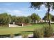 Lush, green landscaping with trees, red flowers, and a staircase to a home in this community at 20638 W Main St, Buckeye, AZ 85396