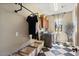 Well-appointed laundry room featuring checkered floors, custom cabinetry, and industrial pipe shelving at 20638 W Main St, Buckeye, AZ 85396