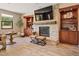 Living area with stacked stone fireplace, built-in shelving, and comfortable seating, perfect for relaxation at 20638 W Main St, Buckeye, AZ 85396