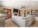 Comfortable living room with a stone fireplace, wooden mantel, and a large grey couch at 20638 W Main St, Buckeye, AZ 85396