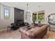 Modern living room with a stylish fireplace, elegant decor, and comfortable seating at 20638 W Main St, Buckeye, AZ 85396