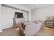 Serene living room features neutral decor and soft carpet, a comfortable couch, and a stylish chest of drawers at 20638 W Main St, Buckeye, AZ 85396