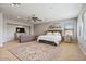 Spacious main bedroom features a sitting area, ceiling fan, and plush carpet at 20638 W Main St, Buckeye, AZ 85396