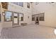 Spacious outdoor patio with stone pavers, string lights and multiple access points for seamless indoor-outdoor living at 20638 W Main St, Buckeye, AZ 85396