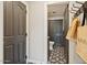 Stylish powder room with decorative tile flooring, modern fixtures, and convenient access from the hallway at 20638 W Main St, Buckeye, AZ 85396