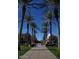 Pathway through town center with lush palm trees and a fountain, offering a relaxing environment at 20638 W Main St, Buckeye, AZ 85396