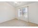 An empty bedroom featuring tile flooring, neutral paint, and natural lighting at 20644 N 30Th Dr, Phoenix, AZ 85027