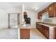 Functional kitchen featuring tile flooring, granite countertops, and wood cabinetry at 20644 N 30Th Dr, Phoenix, AZ 85027