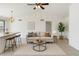 Cozy living room with modern decor, a ceiling fan, and views into the kitchen area at 20644 N 30Th Dr, Phoenix, AZ 85027
