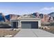 Charming single-story home featuring a gray color scheme, two-car garage, and beautiful mountain views at 2067 W Sheridan Ave, Apache Junction, AZ 85120