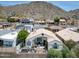 Aerial view of a desert home featuring a backyard patio, mountain views, and low maintenance landscaping at 21 W Cochise Dr, Phoenix, AZ 85021