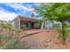 Backyard featuring covered patio with chairs, plants and plenty of gravel at 215 N Power Rd # 33, Mesa, AZ 85205