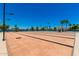 Outdoor bocce ball court with palm trees and shade structure on a clear, sunny day at 215 N Power Rd # 33, Mesa, AZ 85205