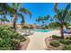 A community pool features lounge chairs, palm trees, landscaping, and walkways at 215 N Power Rd # 33, Mesa, AZ 85205