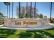 Community entrance sign featuring 'Las Palmas' lettering and manicured landscaping, evoking a sense of luxury at 215 N Power Rd # 33, Mesa, AZ 85205
