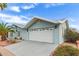 Charming home featuring a two-car garage, desert landscaping and blue vinyl siding at 215 N Power Rd # 33, Mesa, AZ 85205