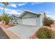 Attractive exterior with blue vinyl siding, desert landscaping and a two-car garage at 215 N Power Rd # 33, Mesa, AZ 85205