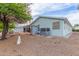 Exterior view of home features a covered patio and a spacious backyard at 215 N Power Rd # 33, Mesa, AZ 85205