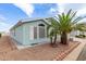 Home exterior showing blue vinyl siding, desert landscaping, shutters and a well-maintained yard at 215 N Power Rd # 33, Mesa, AZ 85205