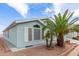 Charming home exterior showcasing blue vinyl siding, desert landscaping and white trim at 215 N Power Rd # 33, Mesa, AZ 85205