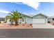 Attractive home exterior with blue vinyl siding, desert landscaping and a two-car garage at 215 N Power Rd # 33, Mesa, AZ 85205