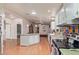 Open Kitchen with white cabinets, multi-color backsplash, and wood flooring at 215 N Power Rd # 33, Mesa, AZ 85205
