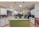 Bright kitchen with white cabinetry, center island and multi-color backsplash at 215 N Power Rd # 33, Mesa, AZ 85205