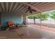 Cozy covered patio seating for relaxing outdoors and enjoying the view of the backyard at 215 N Power Rd # 33, Mesa, AZ 85205