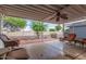 Covered patio with a ceiling fan, chairs, and a view of the backyard at 215 N Power Rd # 33, Mesa, AZ 85205