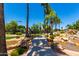 Charming pond featuring a small bridge, rock accents, and lush landscaping at 215 N Power Rd # 33, Mesa, AZ 85205