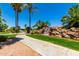 Pond with a rock waterfall feature, palm trees and lush greenery at 215 N Power Rd # 33, Mesa, AZ 85205
