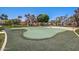 A putting green is surrounded by lush landscaping and green turf at this community at 215 N Power Rd # 33, Mesa, AZ 85205