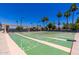 Outdoor shuffleboard courts with a shaded seating area in a well maintained community at 215 N Power Rd # 33, Mesa, AZ 85205