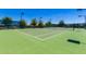 Well-maintained community tennis court with green surface and surrounding fence at 215 N Power Rd # 33, Mesa, AZ 85205