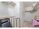 A spacious walk-in closet offers ample storage, shelves, and hanging rods for organization at 215 N Power Rd # 33, Mesa, AZ 85205