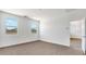 Bright bedroom featuring two windows, neutral walls and flooring, and a paneled door to another room at 2276 W Starfire Ave, Apache Junction, AZ 85120