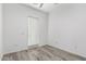 Bright bedroom with wood-look floors, a ceiling fan, a door to the exterior, and many electrical outlets at 2308 E Aster Dr, Chandler, AZ 85286