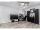A functional bonus room has built-in cabinetry, wood-look flooring, and a ceiling fan in neutral decor at 2308 E Aster Dr, Chandler, AZ 85286