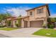Elegant house with a three car garage, manicured lawn, and beautiful stone accents around the courtyard entry at 2308 E Aster Dr, Chandler, AZ 85286