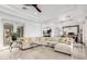 Spacious living area featuring a comfortable sofa, recessed lighting, and marble floors extending into the kitchen at 2308 E Aster Dr, Chandler, AZ 85286
