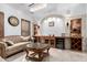 A well-styled living room showcases an ornate stone arch, accent cabinetry, and comfortable seating with a chandelier at 2308 E Aster Dr, Chandler, AZ 85286