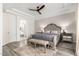 Comfortable main bedroom with ceiling fan, decorative rug, and large arched opening to ensuite bath at 2308 E Aster Dr, Chandler, AZ 85286