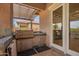 Outdoor kitchen with a built in grill, countertop space, cabinet space, and access to the interior at 2308 E Aster Dr, Chandler, AZ 85286
