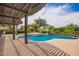 Beautiful pool area with a water feature, patio covering, multiple seating areas and lush landscaping at 2308 E Aster Dr, Chandler, AZ 85286