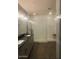 Modern bathroom with double vanity, quartz countertop, large walk-in shower with subway tile, and wood-look flooring at 2425 W Bronco Butte Trl # 2028, Phoenix, AZ 85085