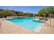 Inviting community pool surrounded by lounge chairs and lush landscaping for relaxing leisure at 2425 W Bronco Butte Trl # 2028, Phoenix, AZ 85085