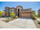 Charming townhome showcasing a two-car garage, desert landscaping, and unique architectural features at 2425 W Bronco Butte Trl # 2028, Phoenix, AZ 85085
