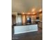 A kitchen featuring a large island with a black countertop, light wood cabinets, and stainless steel appliances at 2425 W Bronco Butte Trl # 2028, Phoenix, AZ 85085