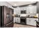 Close-up view of the kitchen featuring stainless appliances and white subway tile backsplash at 2425 W Bronco Butte Trl # 2028, Phoenix, AZ 85085