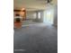 An open-concept living space with a kitchen island and a sliding glass door to a balcony at 2425 W Bronco Butte Trl # 2028, Phoenix, AZ 85085
